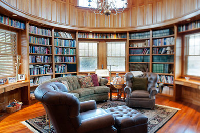 Inspiration for a large timeless dark wood floor home office library remodel in Boston with brown walls