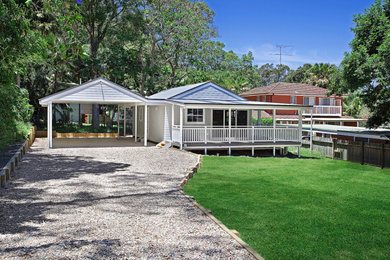 This is an example of a mid-sized traditional home design in Sydney.
