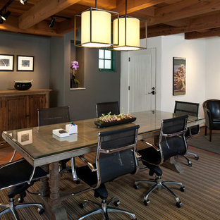 Design ideas for a large modern home office and library in Santa Barbara with white walls, terracotta flooring and a freestanding desk.