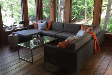 Large trendy screened-in side porch photo in Toronto with decking and a roof extension