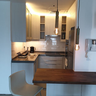 Design ideas for a small modern u-shaped kitchen pantry in Other with a single-bowl sink, flat-panel cabinets, white cabinets, granite benchtops, white splashback, subway tile splashback, stainless steel appliances and grey benchtop.