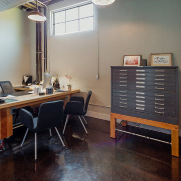 Creative Industrial Workspace Featuring a Custom Wooden Desk and Professional Se