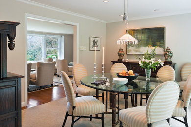 Mid-sized elegant medium tone wood floor enclosed dining room photo in San Francisco with beige walls