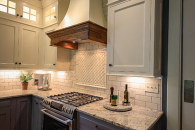 Large country l-shaped dark wood floor and brown floor enclosed kitchen photo in Other with a farmhouse sink, granite countertops, white backsplash, an island, shaker cabinets, blue cabinets, porcelain backsplash, paneled appliances and gray countertops