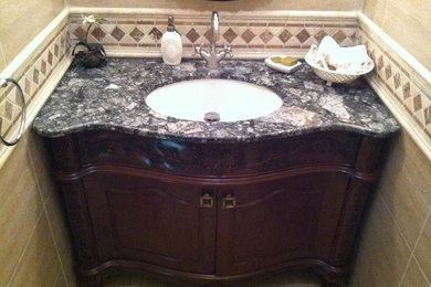 Inspiration for a mid-sized beige tile ceramic tile bathroom remodel in New York with dark wood cabinets, granite countertops and beige walls
