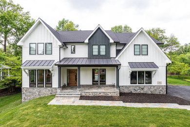Inspiration for a large farmhouse white two-story concrete fiberboard and board and batten exterior home remodel in DC Metro with a shingle roof and a black roof