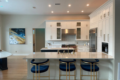 Example of a mid-sized trendy l-shaped eat-in kitchen design in Miami with two islands