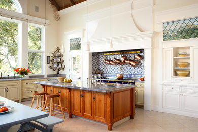 Inspiration for a huge timeless l-shaped ceramic tile open concept kitchen remodel in San Francisco with a double-bowl sink, recessed-panel cabinets, beige cabinets, marble countertops, blue backsplash, stone slab backsplash and colored appliances