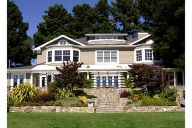 Large transitional brown two-story concrete fiberboard and clapboard exterior home photo in Los Angeles with a shingle roof and a gray roof