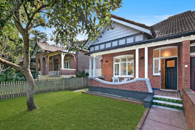 Design ideas for a large one-storey brick brown house exterior in Sydney with a gable roof.
