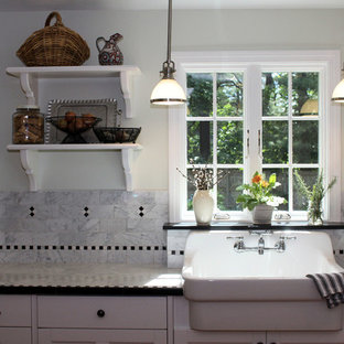 Small traditional kitchen pantry ideas - Kitchen pantry - small traditional l-shaped medium tone wood floor kitchen pantry idea in Bridgeport with a farmhouse sink, recessed-panel cabinets, white cabinets, marble countertops, white backsplash, mosaic tile backsplash and stainless steel appliances