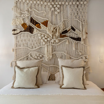 Guest bedroom with paired fibre pendants and macramé wall, Alfragide