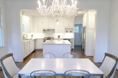 Example of a mid-sized trendy medium tone wood floor and brown floor kitchen/dining room combo design in Atlanta with white walls and no fireplace