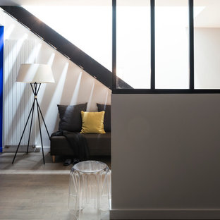 Large trendy open concept medium tone wood floor home theater photo in Grenoble with blue walls and a projector screen