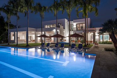 Inspiration for a huge modern white two-story exterior home remodel with a mixed material roof and a white roof