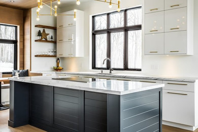 Eat-in kitchen - large transitional l-shaped light wood floor and brown floor eat-in kitchen idea in Calgary with a drop-in sink, flat-panel cabinets, white cabinets, quartzite countertops, white backsplash, paneled appliances, an island and multicolored countertops