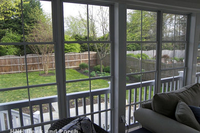 Classic screened-in back porch idea in Baltimore with decking and a roof extension
