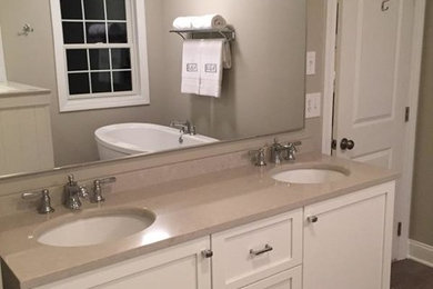 Inspiration for a large contemporary master white tile medium tone wood floor bathroom remodel in Boston with an undermount sink, recessed-panel cabinets, white cabinets, brown walls, a two-piece toilet and quartz countertops