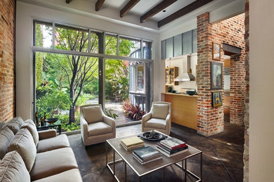Example of a large transitional concrete floor and brown floor family room library design in New Orleans with white walls and no fireplace
