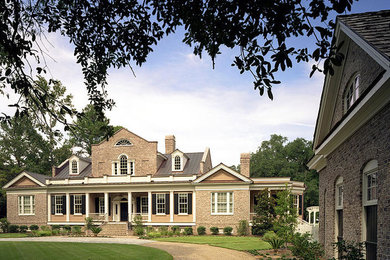 Example of a large classic two-story brick exterior home design in Charlotte