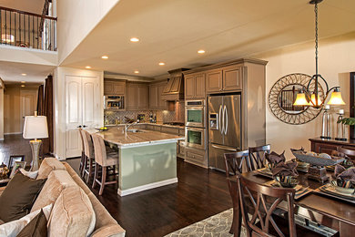 Eat-in kitchen - traditional dark wood floor eat-in kitchen idea in Atlanta with brown cabinets, stainless steel appliances and an island