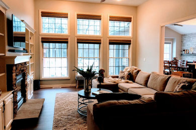 Example of a mid-sized country family room design in Cleveland with a standard fireplace and a wall-mounted tv