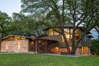 Mid-sized 1960s brown two-story mixed siding exterior home idea in Dallas with a shingle roof