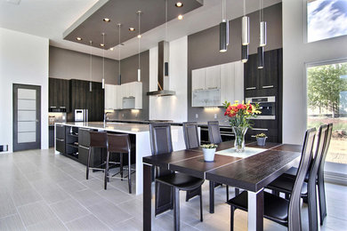 Inspiration for a large contemporary l-shaped open concept kitchen remodel in Albuquerque with an undermount sink, flat-panel cabinets, dark wood cabinets, granite countertops, gray backsplash, stainless steel appliances and an island