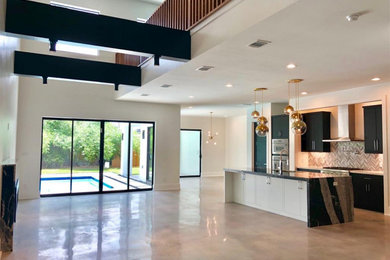 Inspiration for a large contemporary open concept concrete floor, gray floor and exposed beam living room remodel in Houston with a stone fireplace