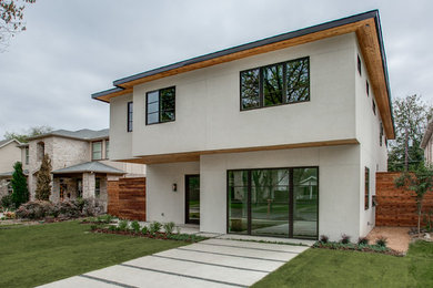 Example of a large classic white two-story stucco exterior home design in Dallas with a hip roof
