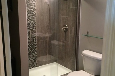 Alcove shower - small contemporary 3/4 beige tile and porcelain tile porcelain tile alcove shower idea in Toronto with recessed-panel cabinets, dark wood cabinets, a two-piece toilet, gray walls and an integrated sink