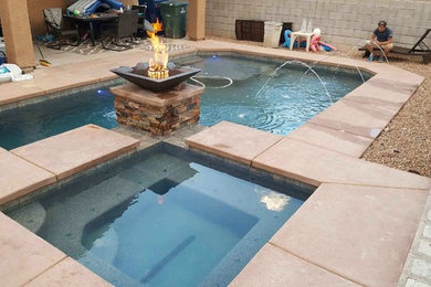 Example of a large minimalist backyard concrete paver and rectangular natural hot tub design in Phoenix