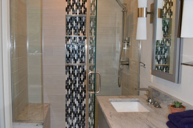 Inspiration for a small transitional master gray tile and porcelain tile ceramic tile and gray floor alcove shower remodel in DC Metro with flat-panel cabinets, gray cabinets, a two-piece toilet, gray walls, an undermount sink, granite countertops, a hinged shower door and gray countertops