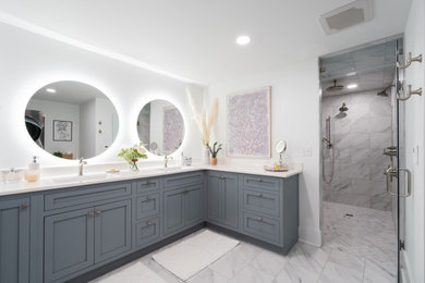 Wet room - large modern master ceramic tile, white floor and double-sink wet room idea with flat-panel cabinets, gray cabinets, white walls, an integrated sink, quartz countertops, a hinged shower door, white countertops and a freestanding vanity