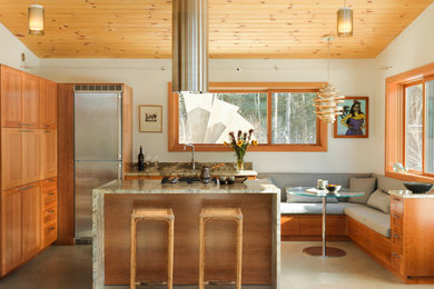 Small minimalist l-shaped concrete floor and gray floor eat-in kitchen photo in Burlington with an island, an undermount sink, shaker cabinets, light wood cabinets, granite countertops, gray backsplash, stone slab backsplash and stainless steel appliances