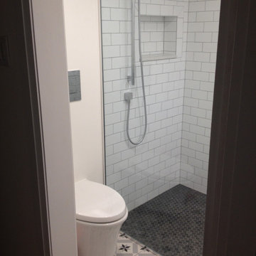 Small bathroom in a basement with low ceiling