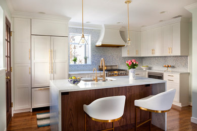 Design ideas for a small transitional l-shaped eat-in kitchen in Philadelphia with an undermount sink, white cabinets, quartzite benchtops, blue splashback, mosaic tile splashback, medium hardwood floors, with island and stainless steel appliances.