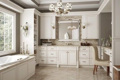 Bathroom - mid-sized traditional master brown tile and stone tile marble floor bathroom idea in Raleigh with recessed-panel cabinets, white cabinets, an undermount tub, white walls, an undermount sink and marble countertops