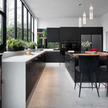 Contemporary black kitchen in extended cottage
