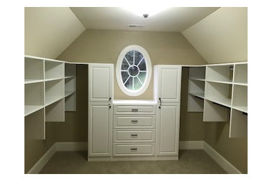 Mid-sized elegant gender-neutral carpeted and beige floor walk-in closet photo in Other with raised-panel cabinets and white cabinets