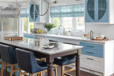 Kitchen - large transitional brown floor and dark wood floor kitchen idea in Raleigh with an undermount sink, blue cabinets, quartz countertops, white backsplash, stainless steel appliances, an island, glass-front cabinets and ceramic backsplash