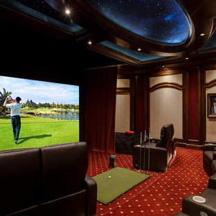 Home theater - traditional enclosed carpeted and multicolored floor home theater idea in Orlando with beige walls and a projector screen