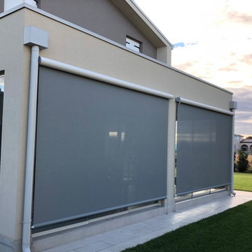 scorrevole tutto vetro e tende filtranti su portico