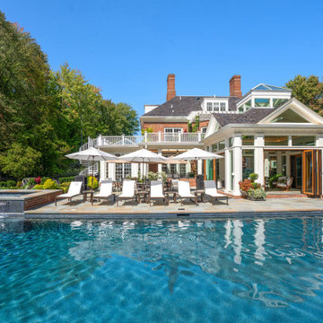 Backyard pool and spa with the open four-season glass cabana and outdoor lounge