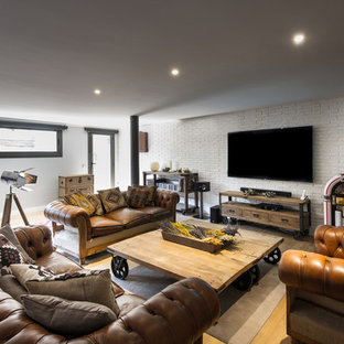 Large mediterranean walk-out basement in Barcelona with white walls, medium hardwood flooring and no fireplace.