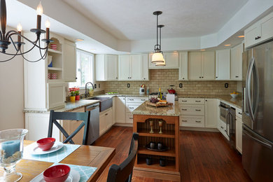 Eat-in kitchen - mid-sized transitional u-shaped medium tone wood floor and brown floor eat-in kitchen idea in Baltimore with a farmhouse sink, flat-panel cabinets, granite countertops, beige backsplash, stone tile backsplash, stainless steel appliances, an island and white cabinets