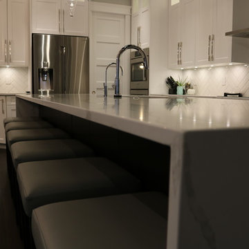 White Cabinetry with White Quartz Island