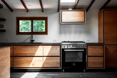 Mid-sized danish u-shaped eat-in kitchen photo in Los Angeles with flat-panel cabinets and medium tone wood cabinets