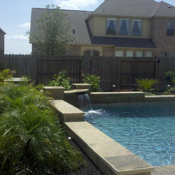 Geometric Pool with Stacked Stone Raised Beam wall with Scupper