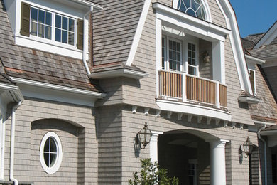 Design ideas for an expansive traditional three-storey grey exterior in New York with wood siding and a hip roof.